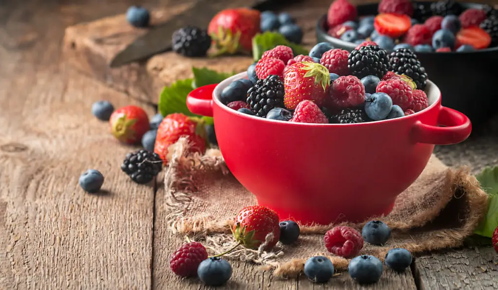 different type of berries in a red bowl