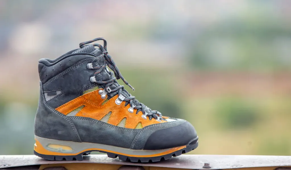 A leather trekking hiking winter boot on blurred background