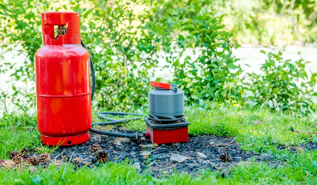 Camping with a gas kettle. kettle boiling on a camping stove to make tea