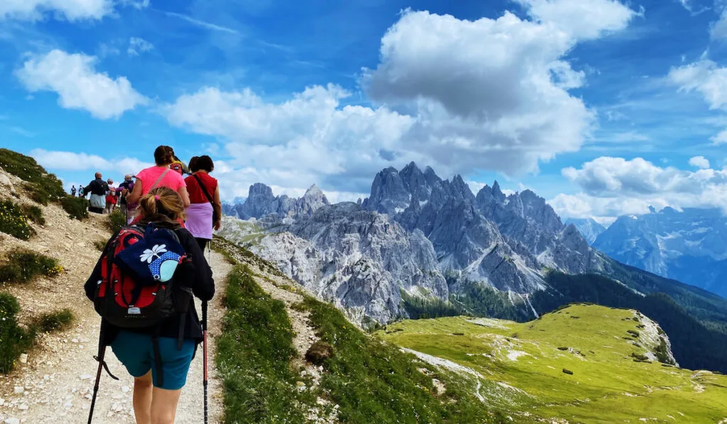 Group of hikers hiking mountain trail
