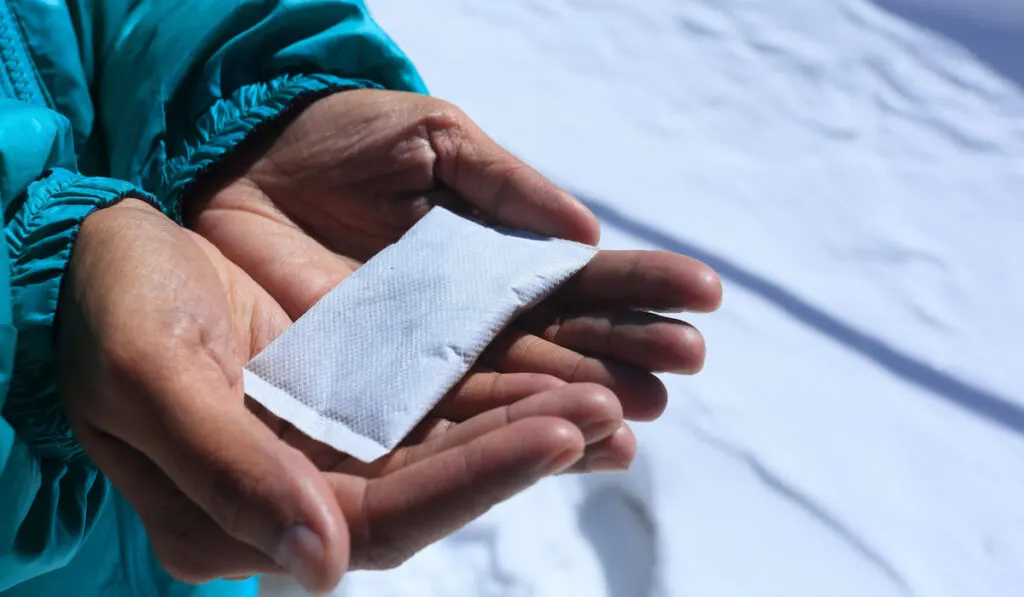 Hand warmer holds on hand of a woman during  winter season 