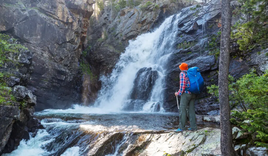 Hiker looking at a waterfall