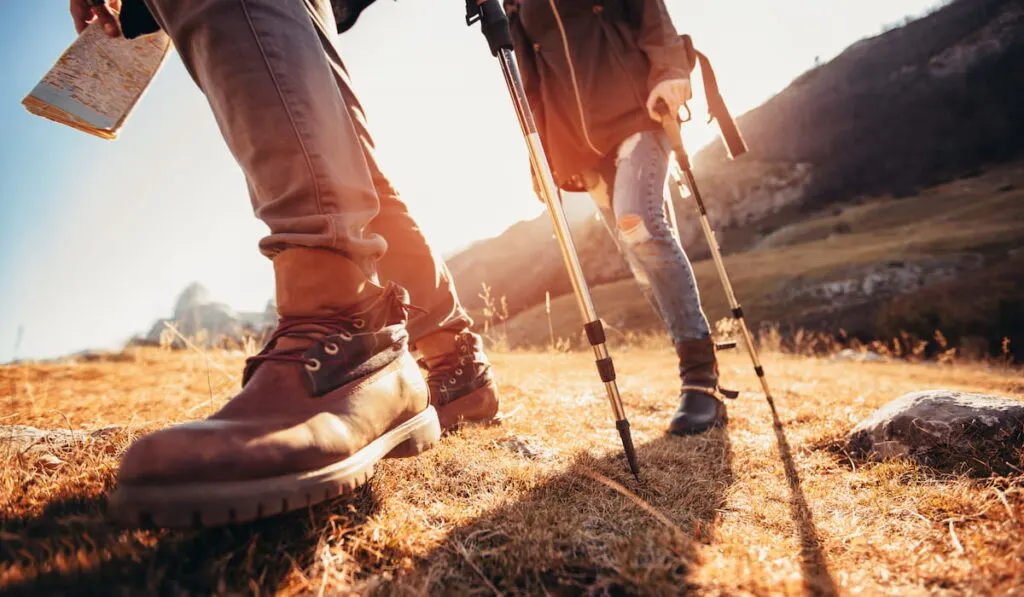 Hiking man and woman with trekking boots on the trail