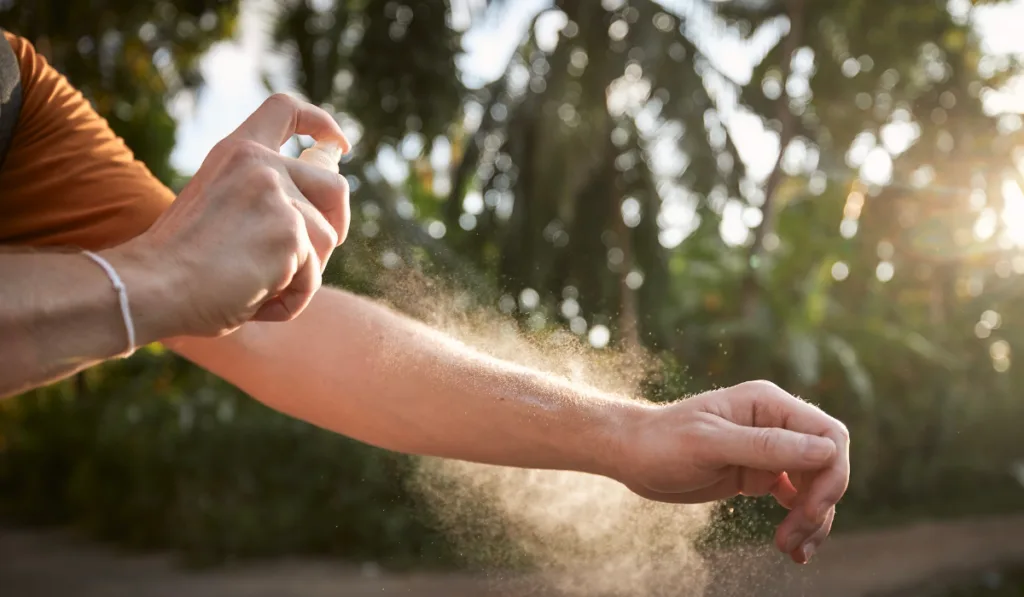 Man applying insect repellent on his hand