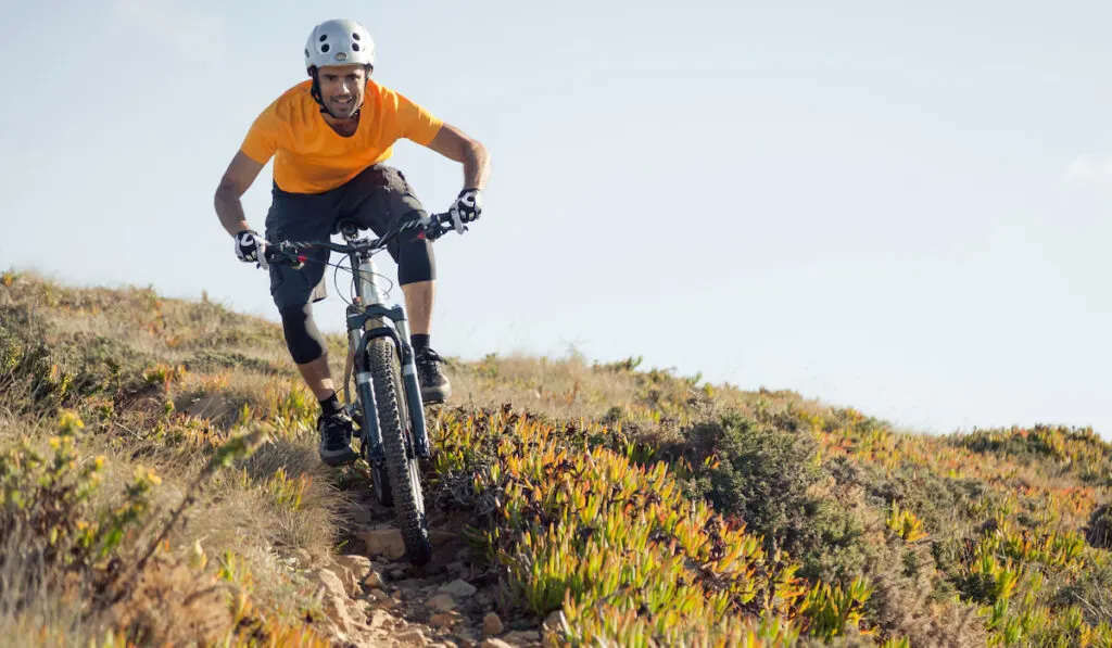 Mountain biker riding dirt trail
