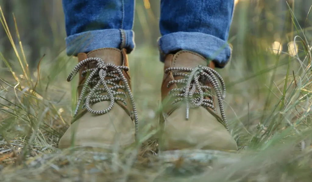 Person in boots and jeans,  walk in the forest