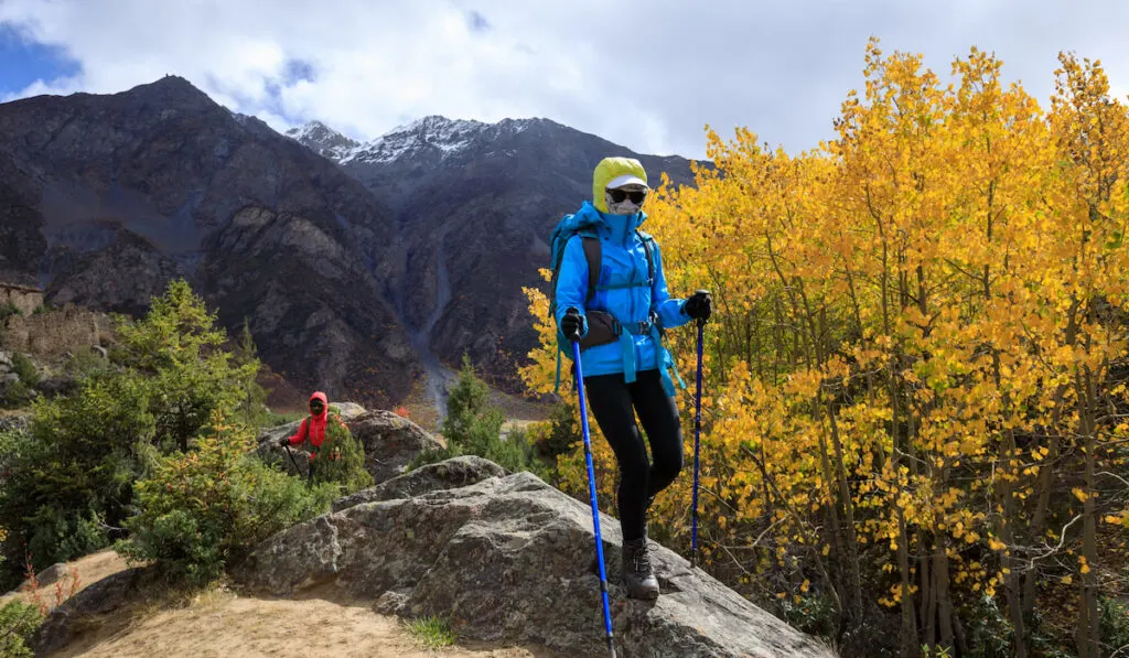 Two women hikers hiking in winter mountains
