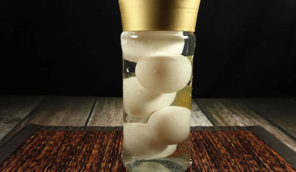 eggs in glass bottle with water on dark background