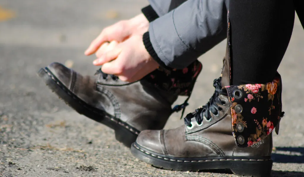 woman tying doc martens shoe lace