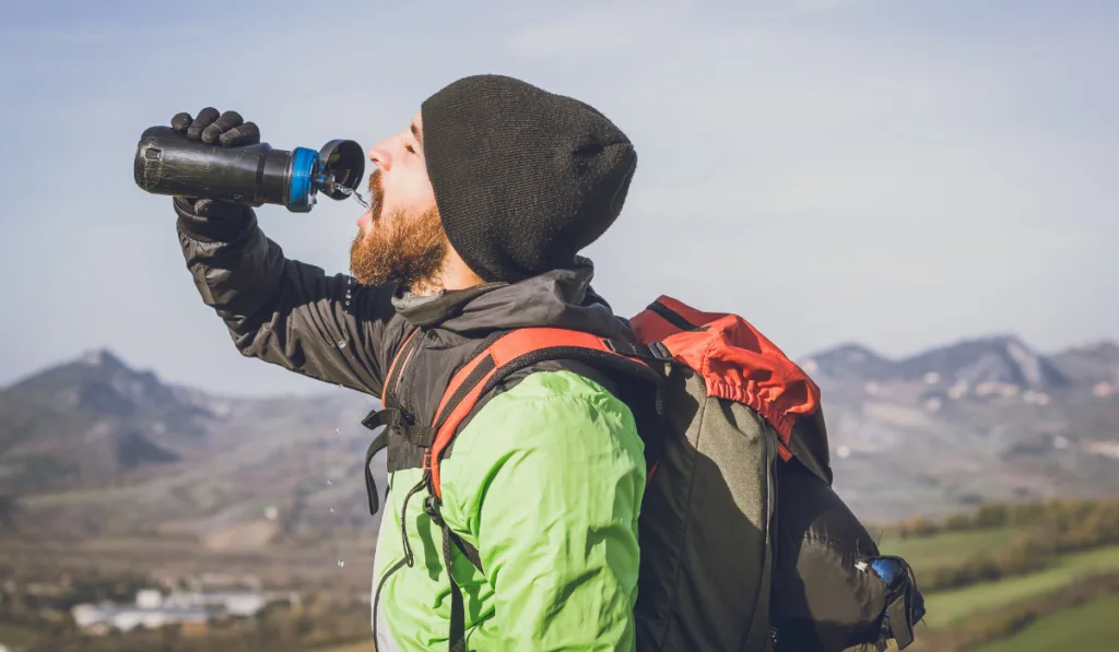 Hiker on an excursion in the nature - Tourist having a pause while on a trekking tour.