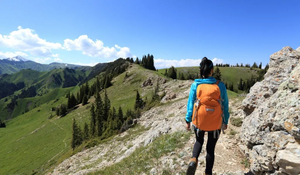 young woman backpacker hiking 